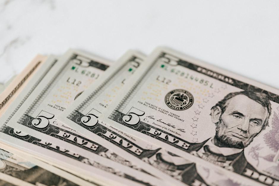 Image of a person celebrating on top of a pile of money, symbolizing financial liberation