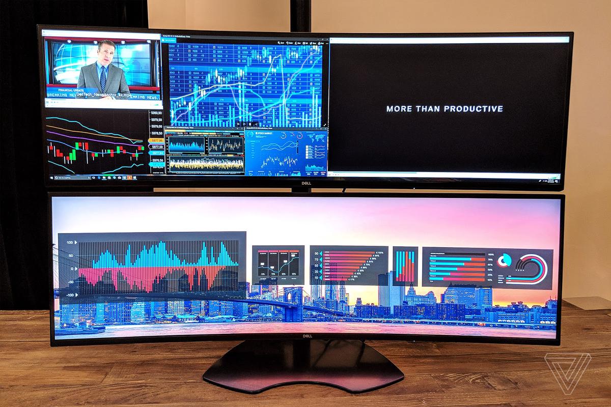 A well-organized home office setup with ergonomic furniture, multiple monitors, and video conferencing equipment