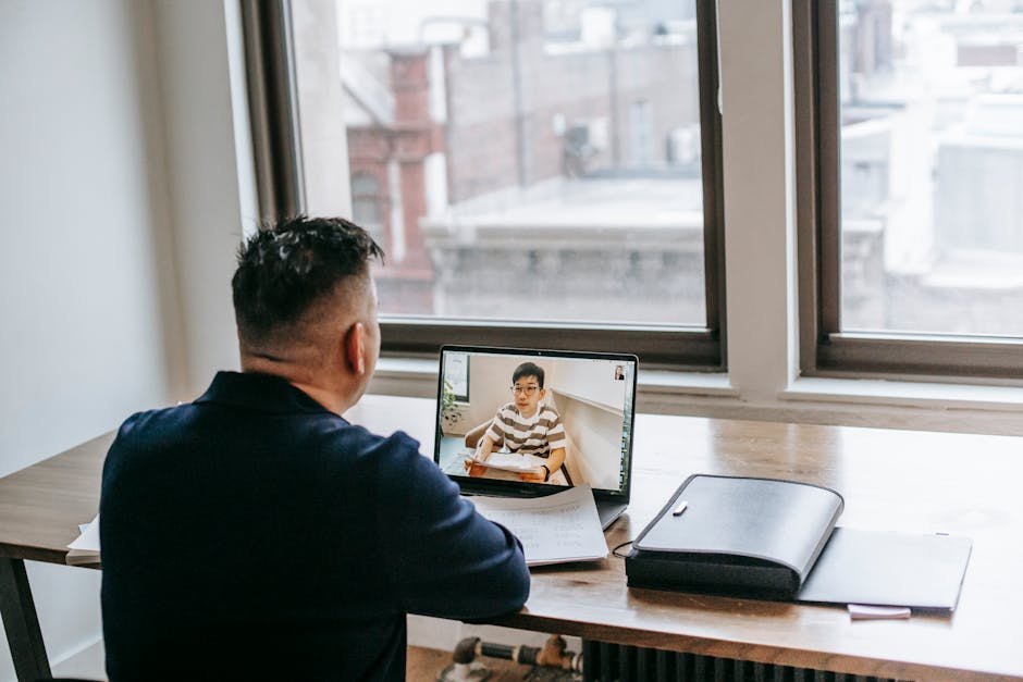 A person conducting an online tutoring session using a computer and headset in a home office