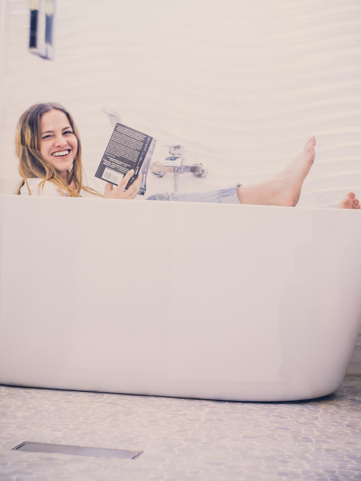 Image description: A person holding a house model in their hands, symbolizing investment in real estate.