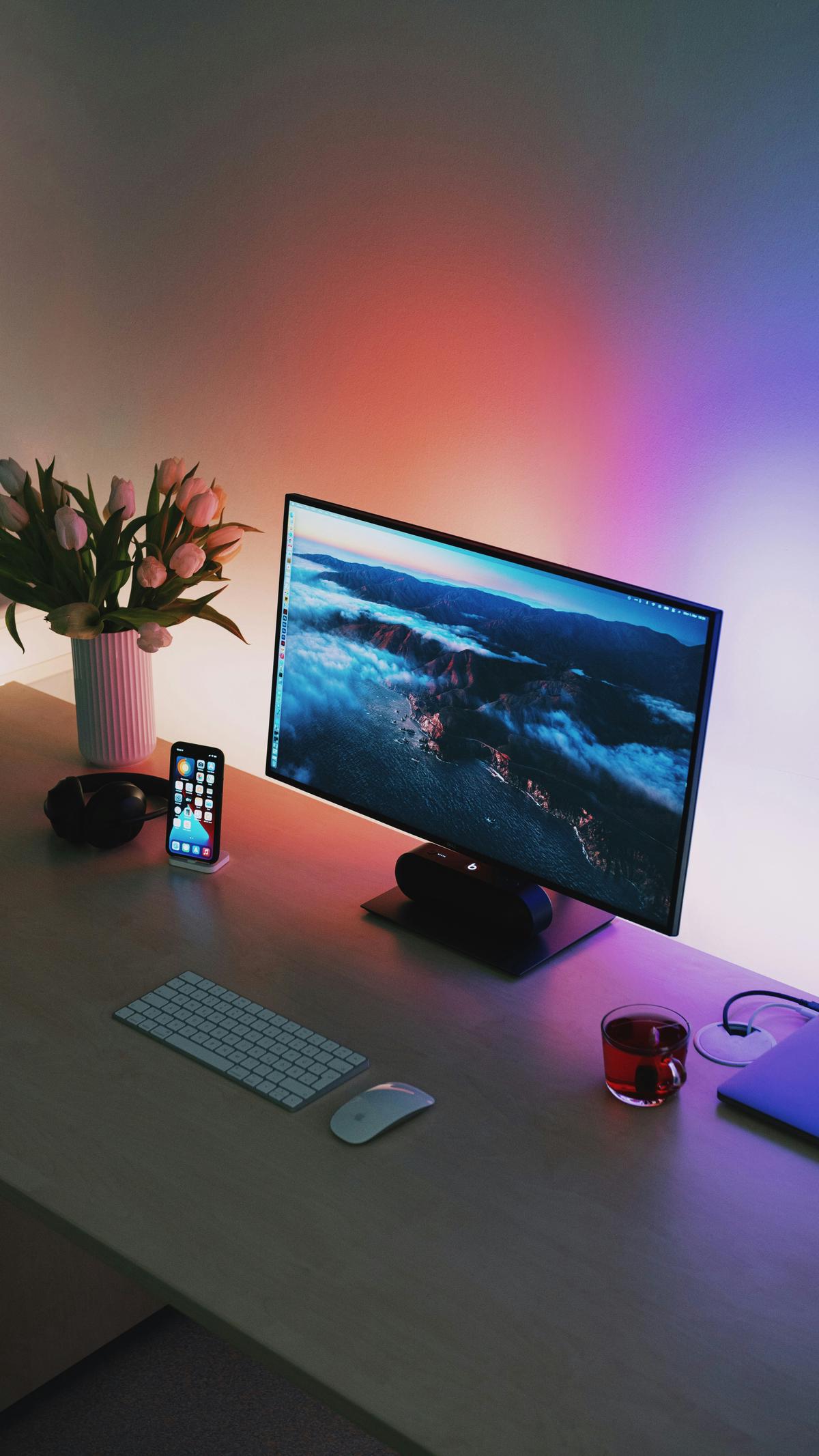 A desk setup with various digital tools and devices used for remote work